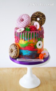 Rainbow Doughnuts Dripping Birthday Cake MK Cakes | One-of-a-kind cakes for every occasion